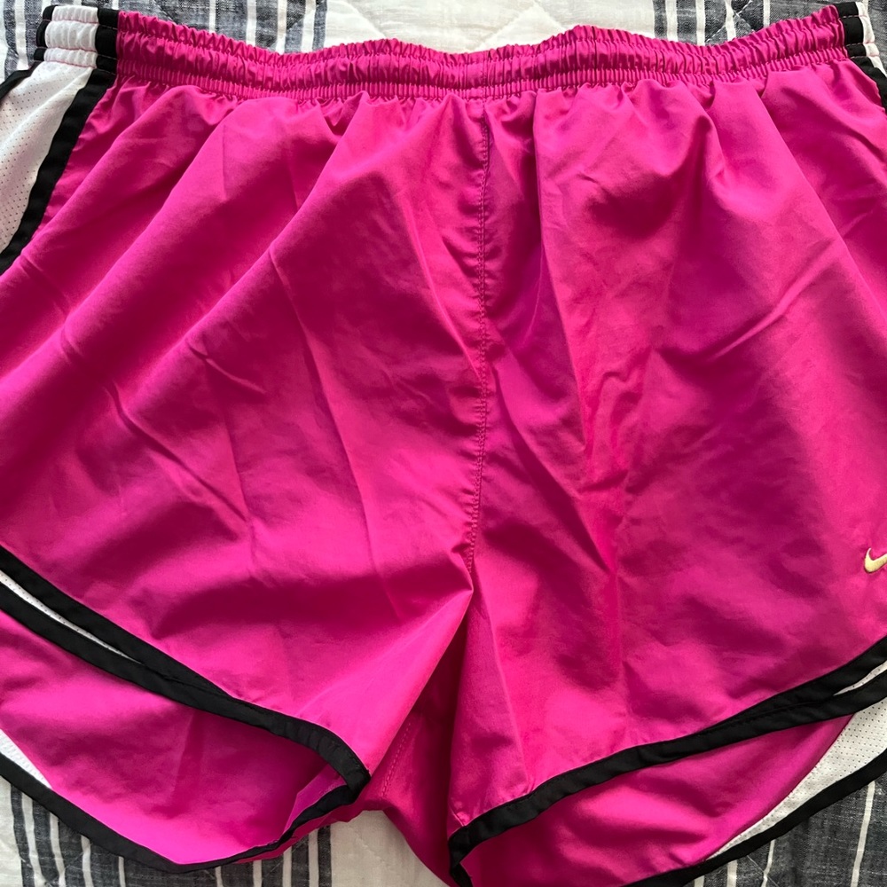 Magenta Nike athletic shorts.